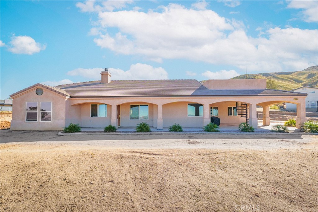 23053 Roundup Way Apple Valley, CA 92308 - Photo 1 of 46 a front view of a house with a yard