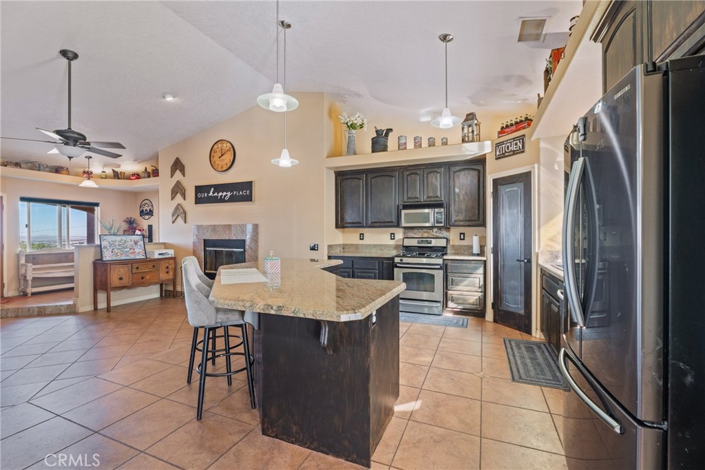 23053 Roundup Way Apple Valley, CA 92308 - Photo 15 of 46 a kitchen with stainless steel appliances granite countertop a sink a refrigerator and a stove