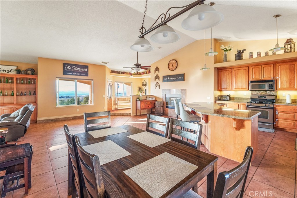 23053 Roundup Way Apple Valley, CA 92308 - Photo 16 of 46 a living room with lots of furniture and a open kitchen view
