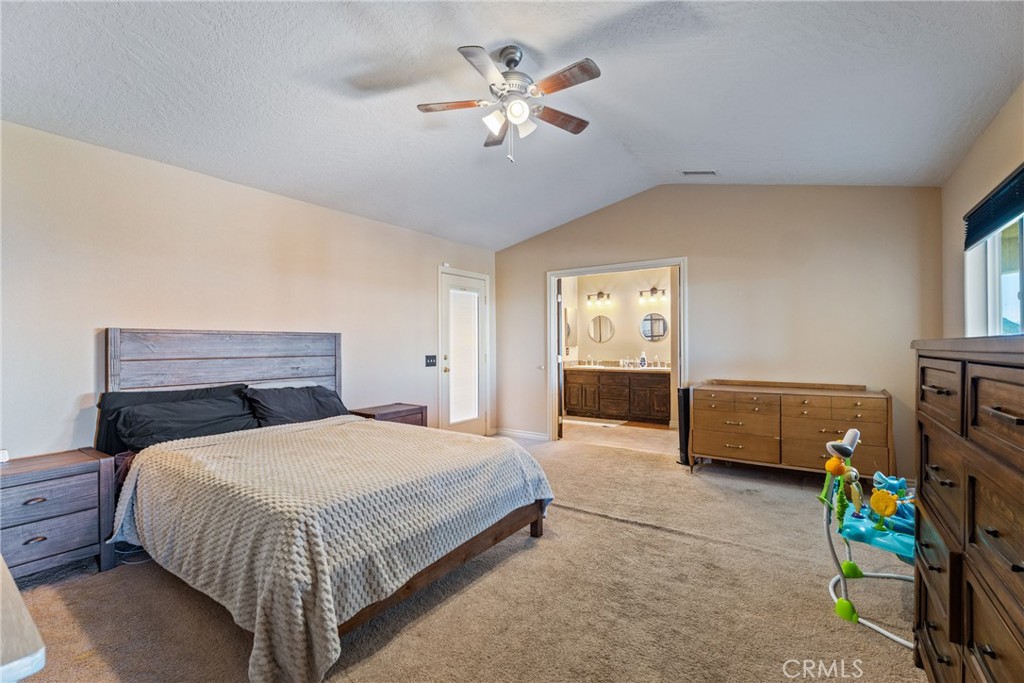 23053 Roundup Way Apple Valley, CA 92308 - Photo 22 of 46 a bedroom with a bed and a couch