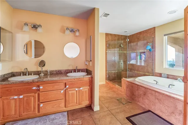 a spacious bathroom with a tub shower and window