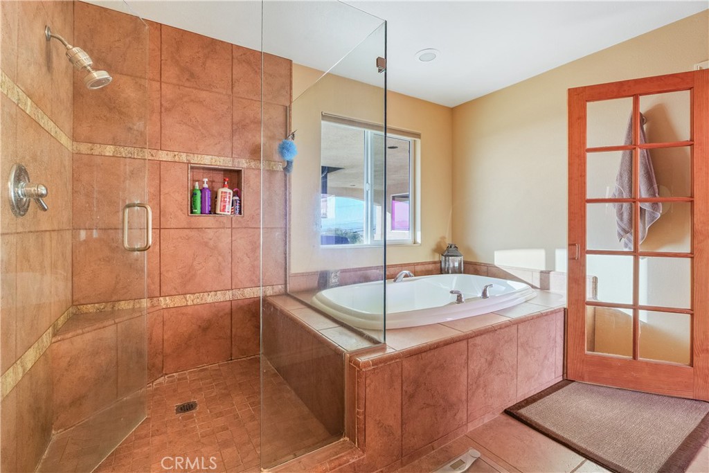 23053 Roundup Way Apple Valley, CA 92308 - Photo 28 of 46 a bathroom with a tub a sink and a shower