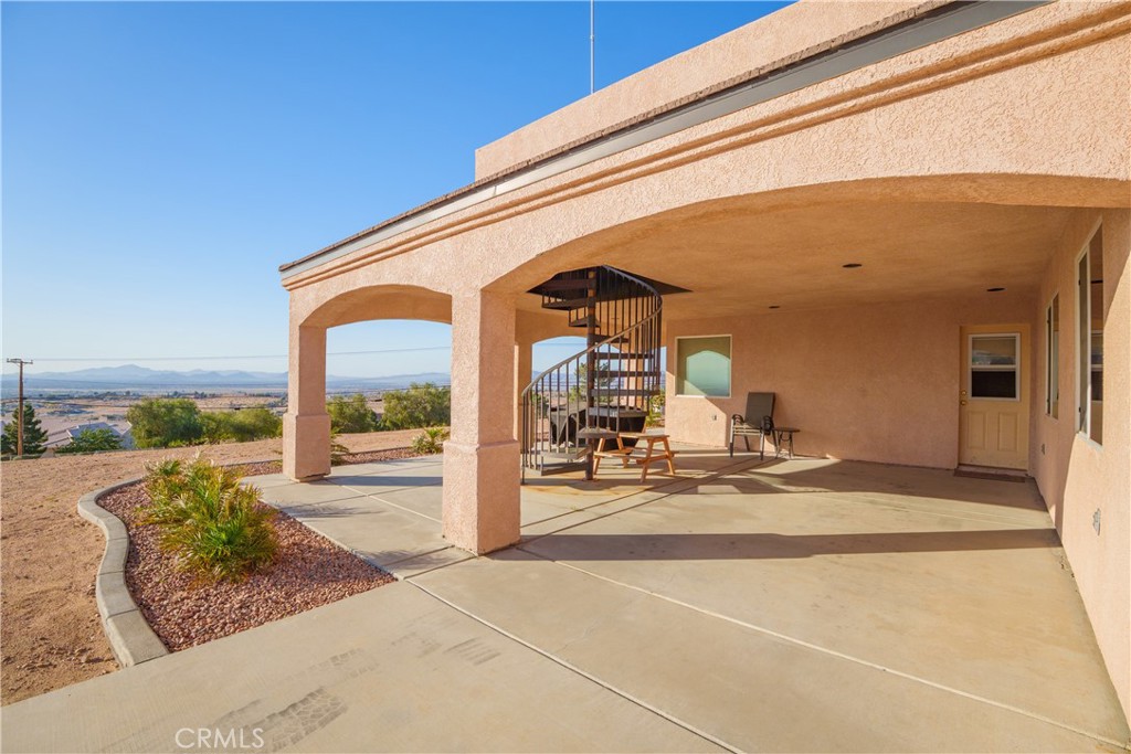 23053 Roundup Way Apple Valley, CA 92308 - Photo 3 of 46 a view of a house with a patio