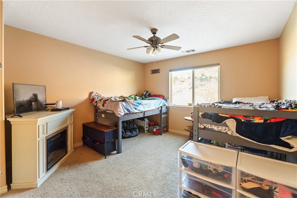 23053 Roundup Way Apple Valley, CA 92308 - Photo 31 of 46 a bedroom with bed and window