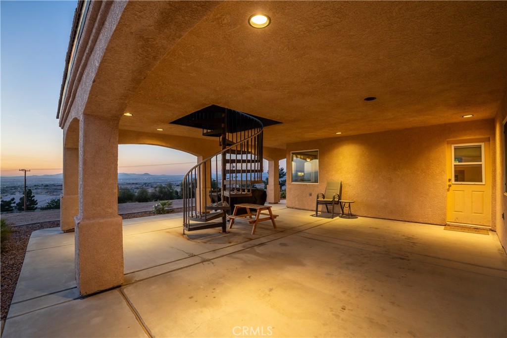 23053 Roundup Way Apple Valley, CA 92308 - Photo 7 of 46 a view of a patio with a table and chairs under an umbrella with a patio