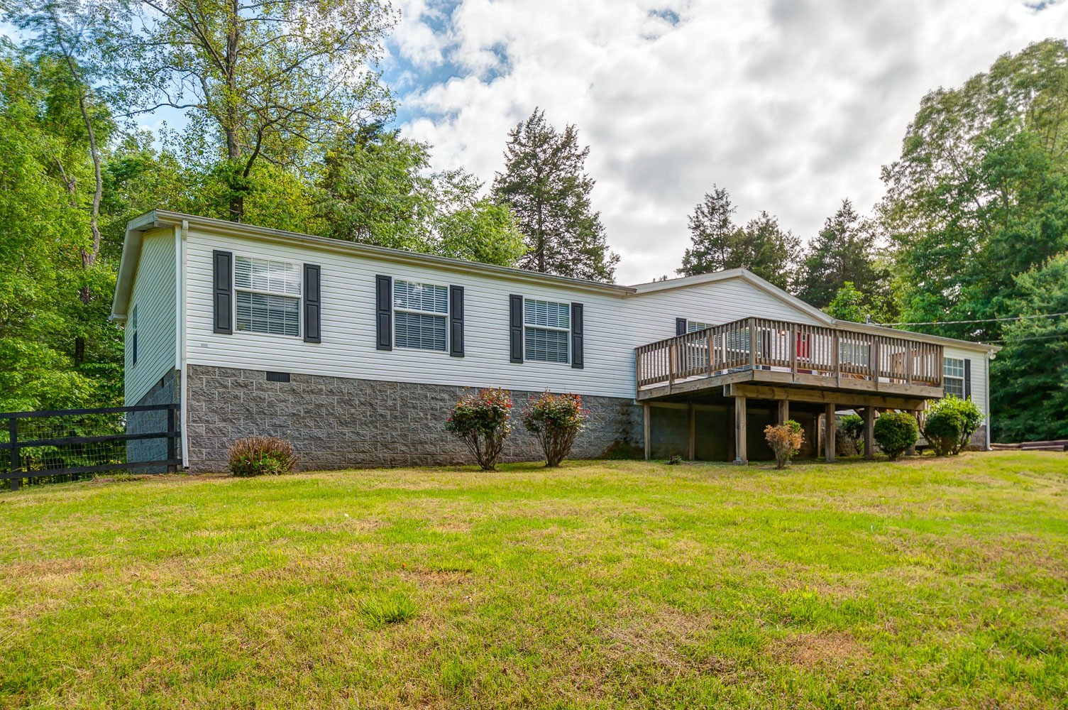 a front view of house with yard and swimming pool