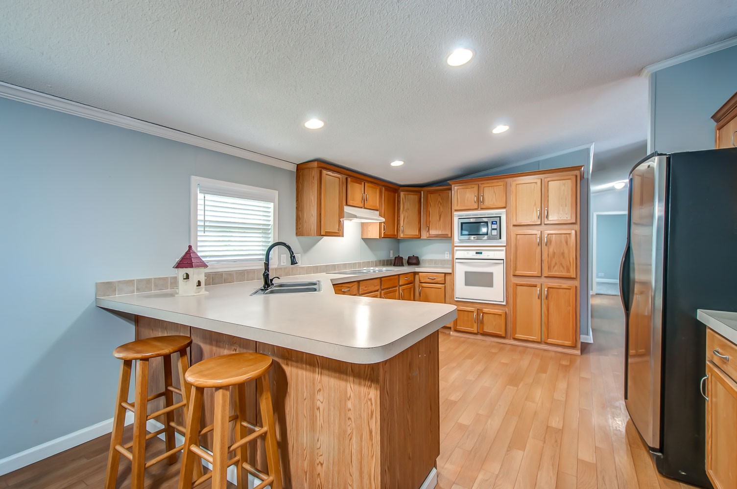 105 Fisher Road Dickson, TN 37055 - Photo 11 of 43 a kitchen with stainless steel appliances granite countertop a sink a stove and a refrigerator