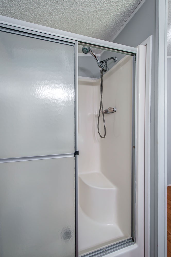 105 Fisher Road Dickson, TN 37055 - Photo 24 of 43 a bathroom with a glass shower door
