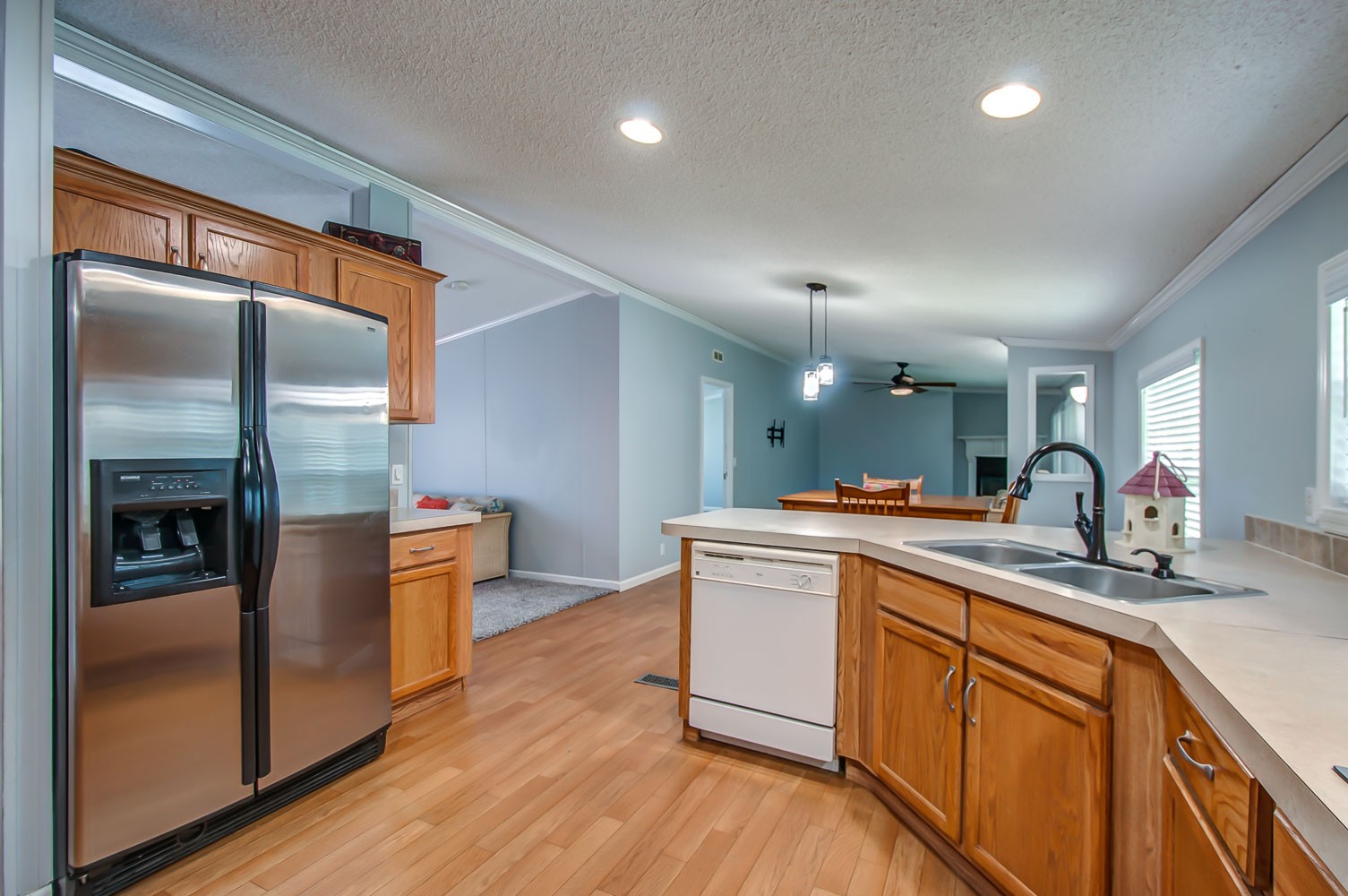 105 Fisher Road Dickson, TN 37055 - Photo 10 of 43 a kitchen with stainless steel appliances granite countertop a refrigerator a sink dishwasher a stove and white countertops with wooden floor