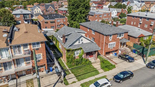 an aerial view of multiple houses with a yard
