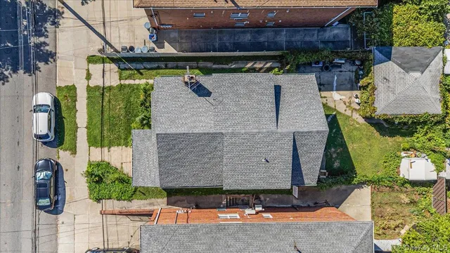 an aerial view of a house with garden space and street view