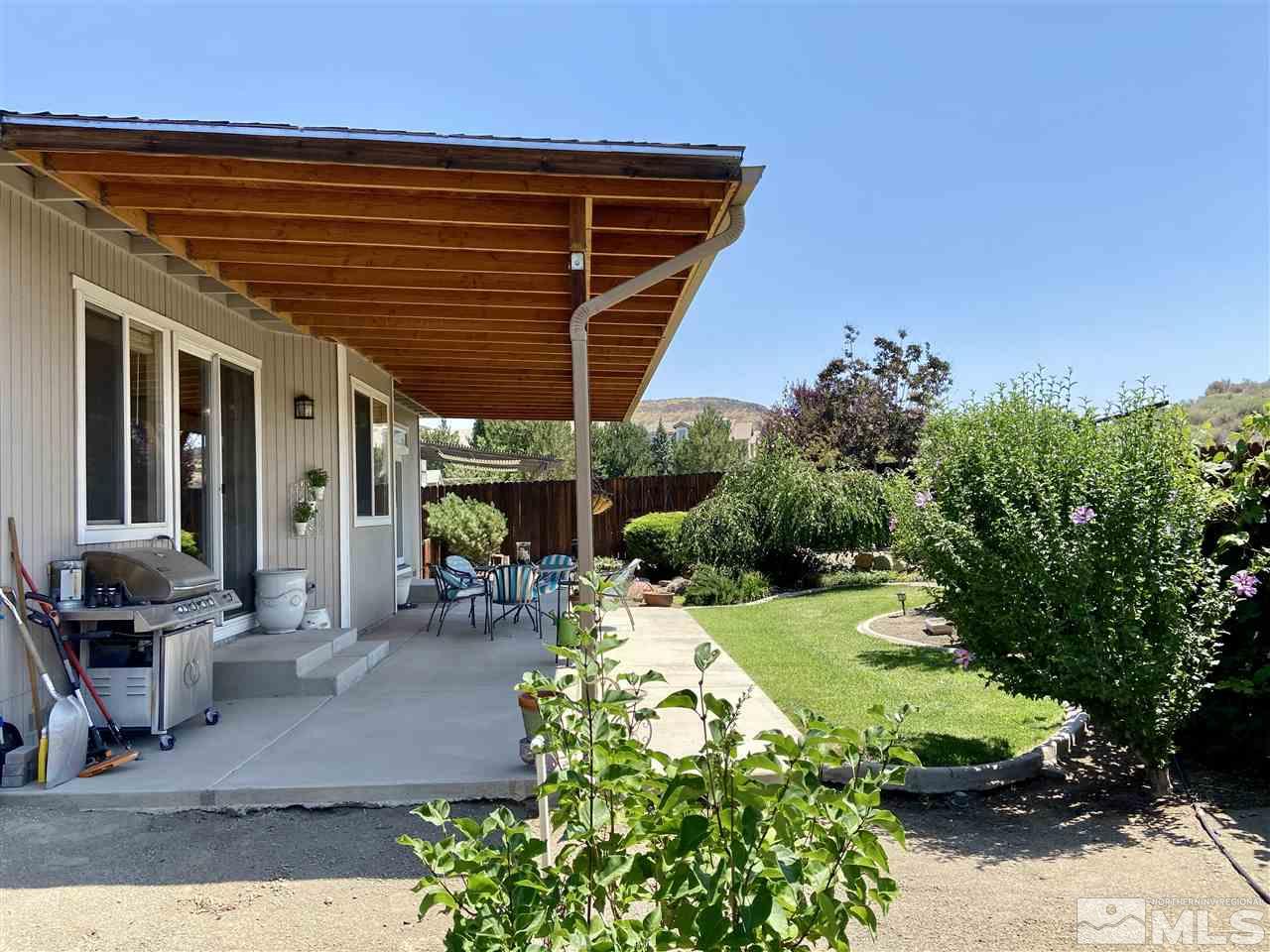1486 Amston Road Reno, NV 89511 - Photo 14 of 18 a patio with table and chairs and potted plants