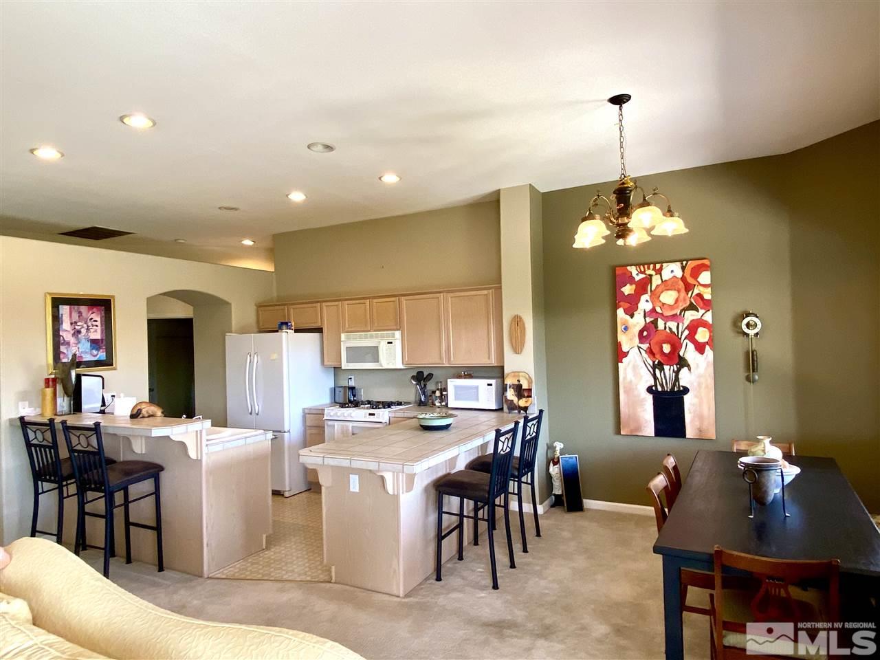1486 Amston Road Reno, NV 89511 - Photo 4 of 18 a very nice looking dining room with a large dining table and a chandelier