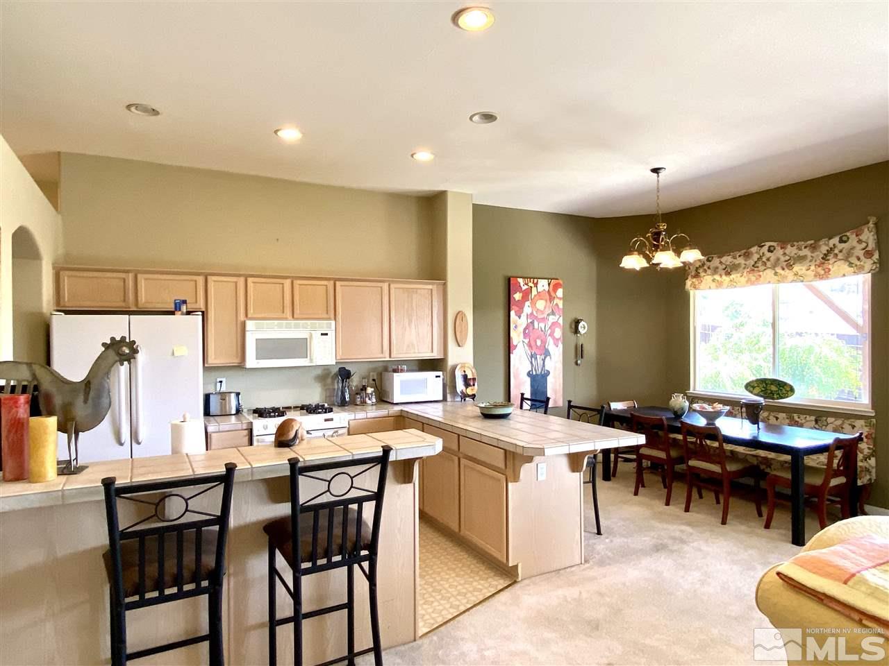 1486 Amston Road Reno, NV 89511 - Photo 5 of 18 a kitchen with a table chairs stove and cabinets