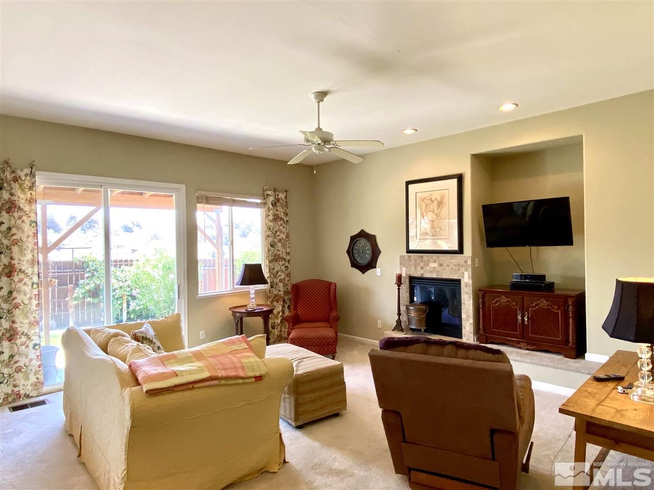 1486 Amston Road Reno, NV 89511 - Photo 6 of 18 a living room with fireplace furniture and a flat screen tv