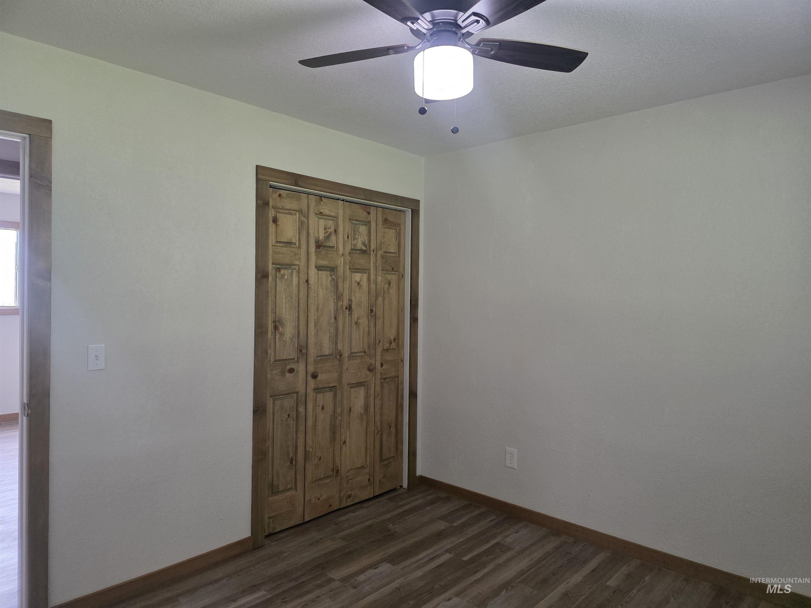 310 Fir Road Kamiah, ID 83536 - Photo 20 of 32 Interior room featuring light-toned walls, wood-finish flooring, and a ceiling fan with integrated lighting