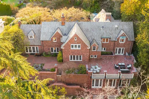 a aerial view of a house with a yard and sitting area