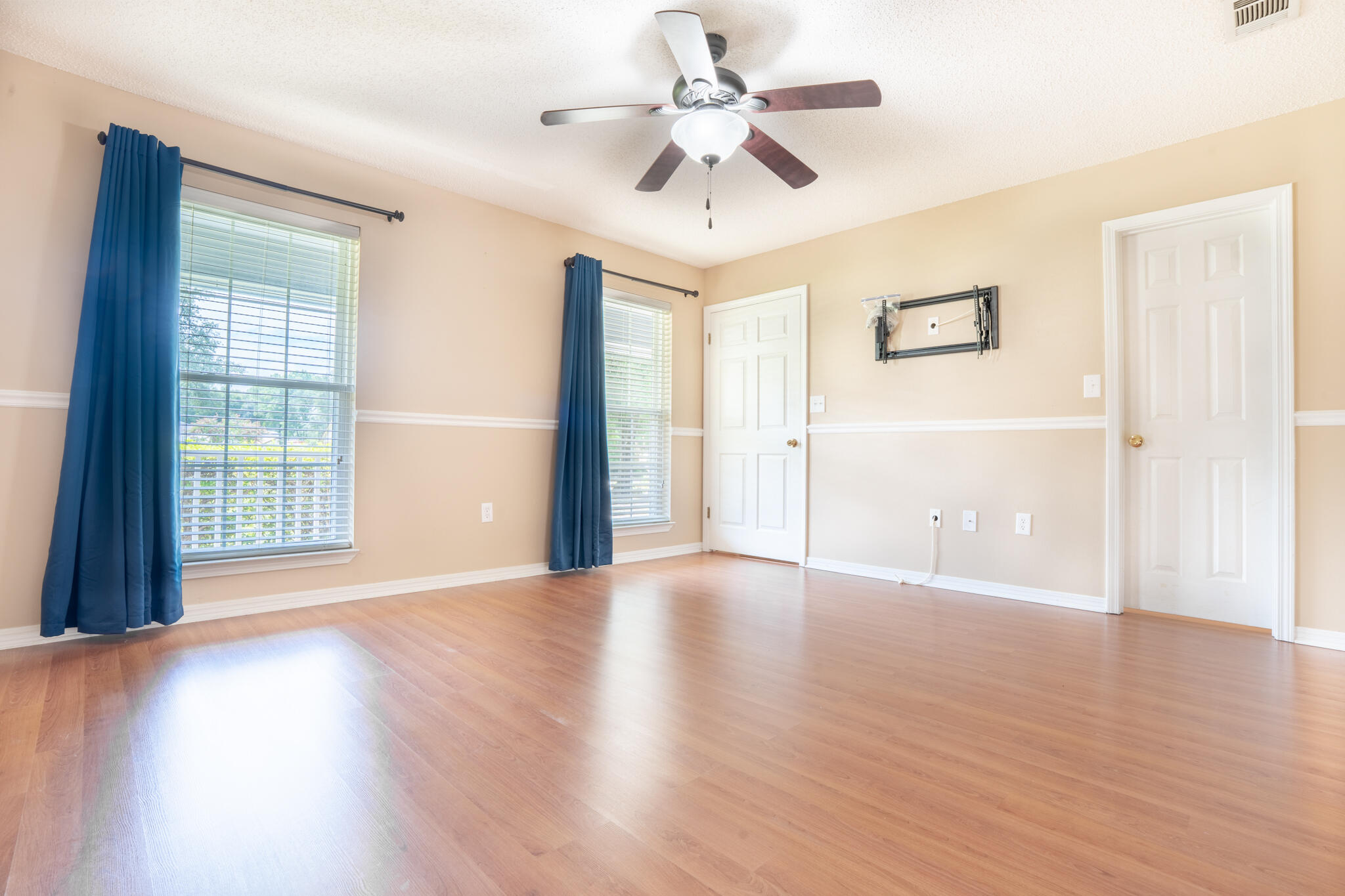 2786 Willow Bend Court Crestview, FL 32539 - Photo 12 of 32 a view of an empty room with a window and wooden floor