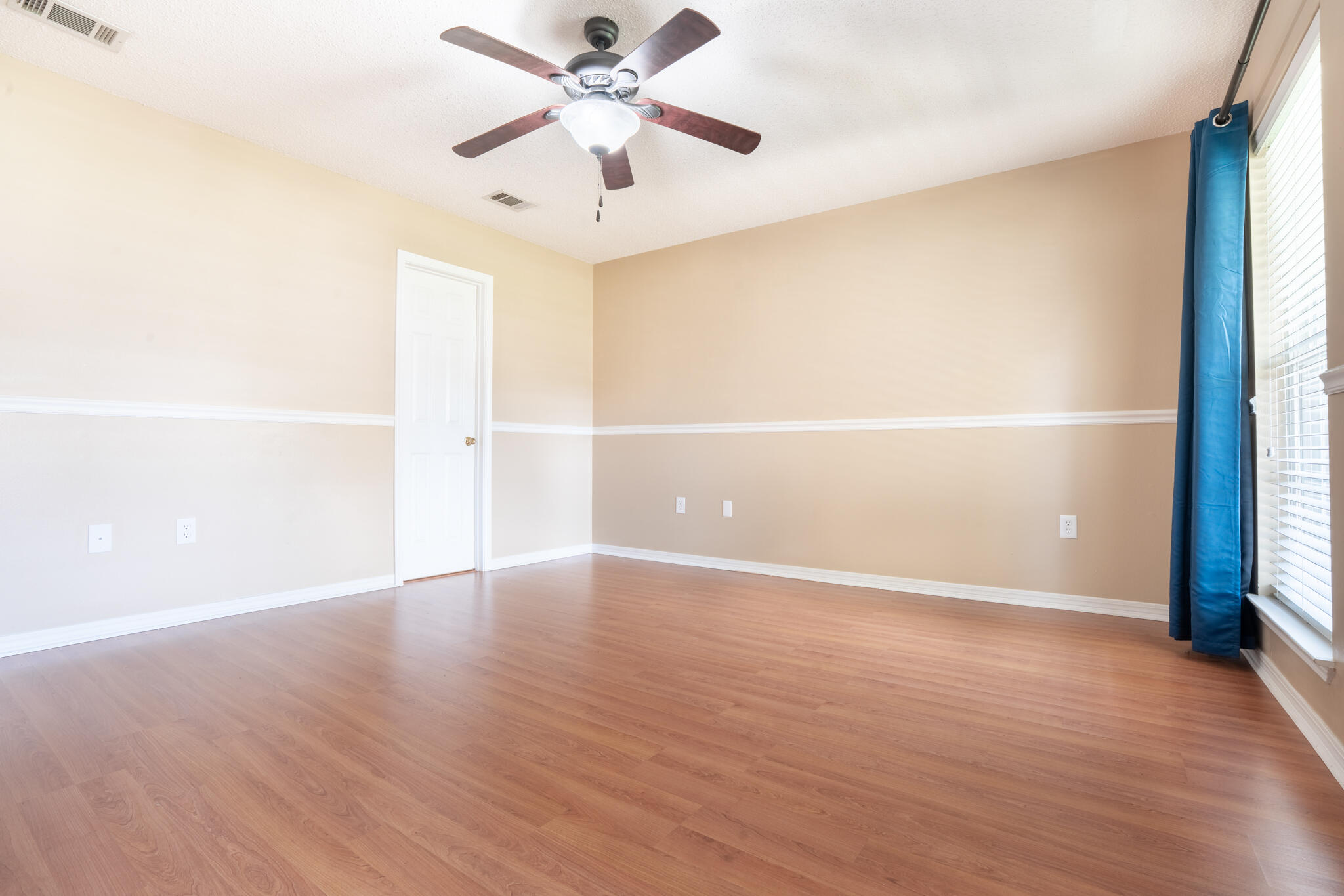 2786 Willow Bend Court Crestview, FL 32539 - Photo 13 of 32 a view of an empty room with wooden floor