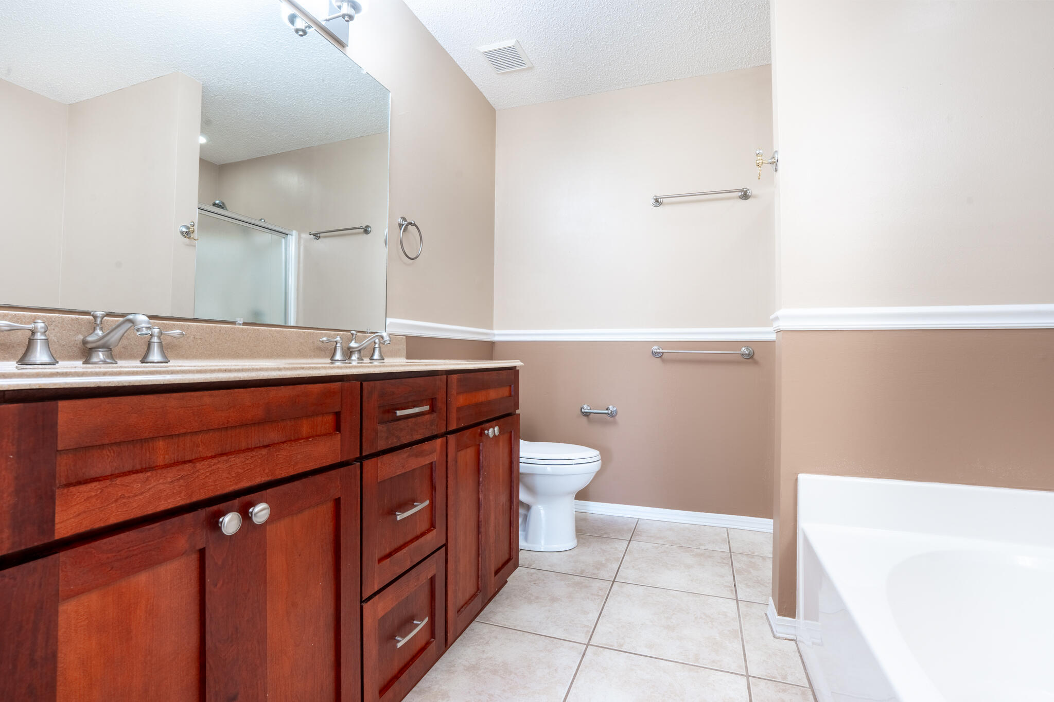 2786 Willow Bend Court Crestview, FL 32539 - Photo 14 of 32 a bathroom with a sink a toilet a mirror and vanity