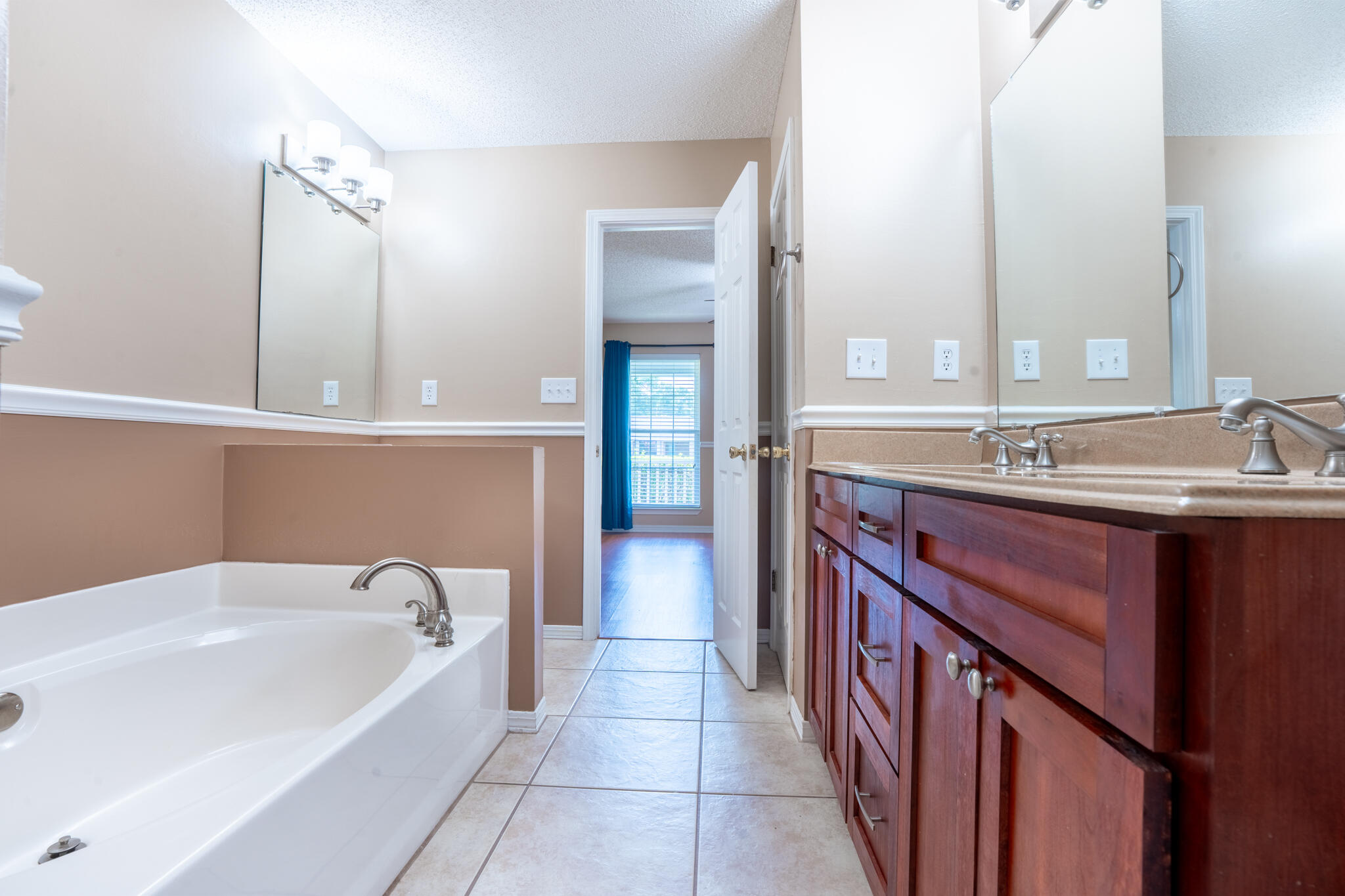 2786 Willow Bend Court Crestview, FL 32539 - Photo 15 of 32 a spacious bathroom with a bathtub sink and mirror