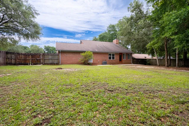 a view of a house with a yard and sitting area