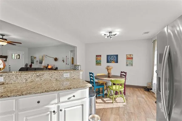 a view of a kitchen counter space and dining room
