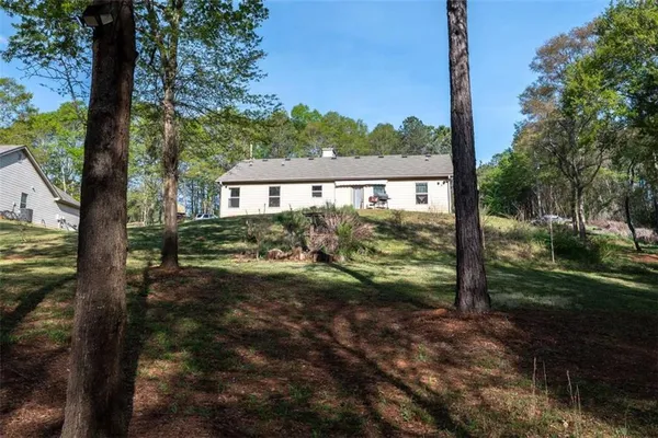 a view of a yard in front of a house with a tree
