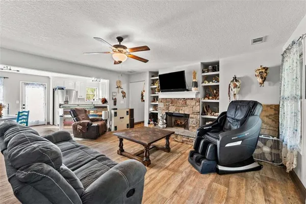 a living room with furniture a fireplace and a flat screen tv