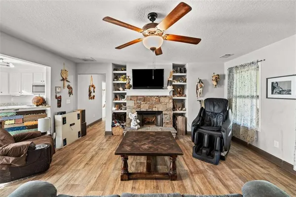 a living room with furniture a flat screen tv and a fireplace