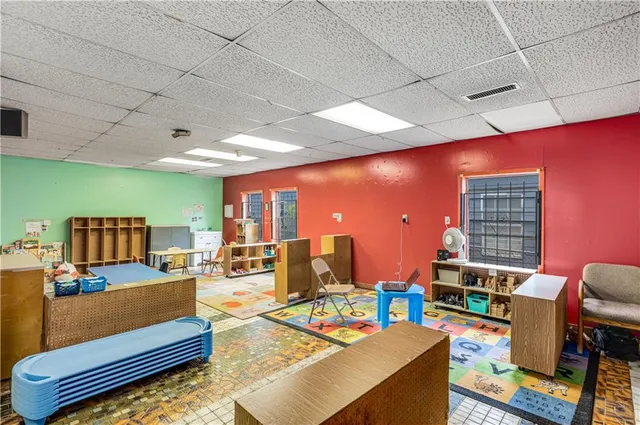 a living room with furniture a rug and a large window