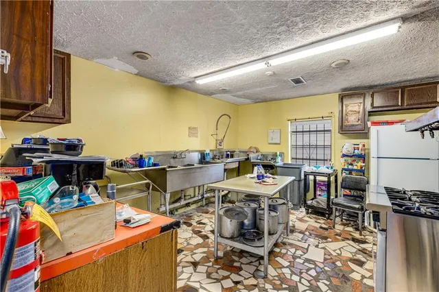 a view of a dining room with a table and chairs