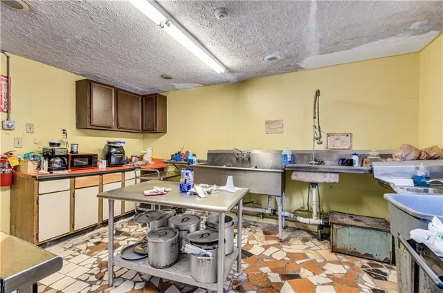 a kitchen with a table chairs stove and kitchen view