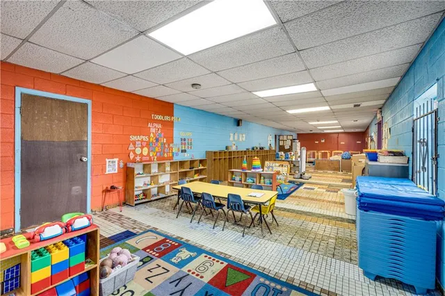 a view of a dining hall with lots of tables and chairs