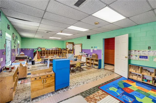 a bed room with furniture and a book shelf
