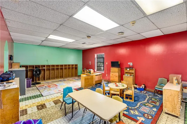 a living room with furniture a rug and a projector
