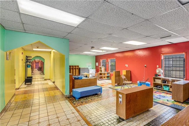 a living room with furniture a rug and a chandelier