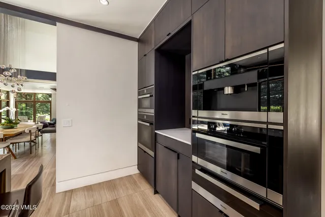 a living room with furniture a fireplace and a large window
