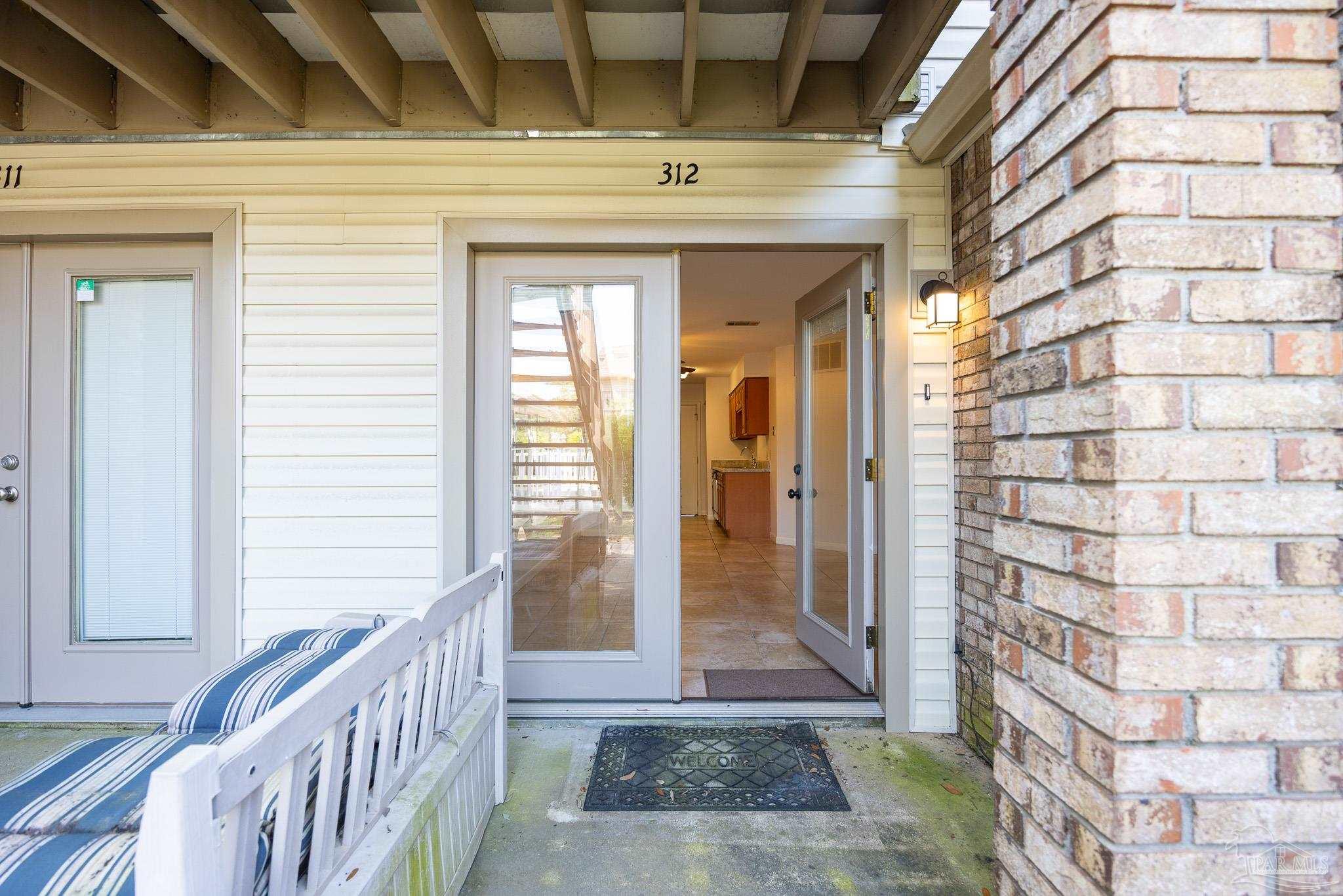 7150 Plantation Road, Unit 312 Pensacola, FL 32504 - Photo 11 of 14 a view of a brick house with large windows