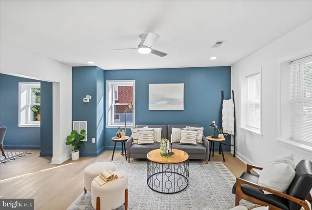 a living room with furniture a table and chair