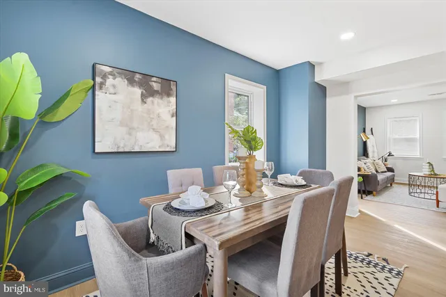 a dining room with furniture and wooden floor