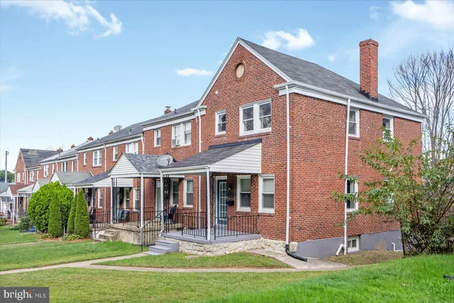 a front view of a house with a yard table and chairs
