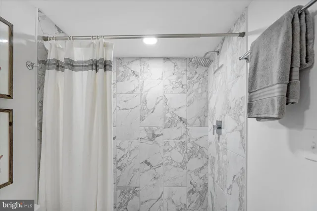 a bathroom with a shower and a glass door