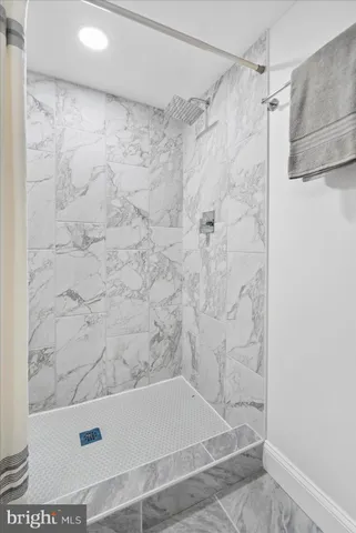 a bathroom with a shower and a bath tub