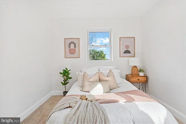 a bedroom with a bed and a painting on the wall