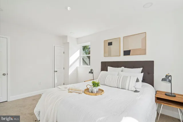 a bedroom with a bed and a table