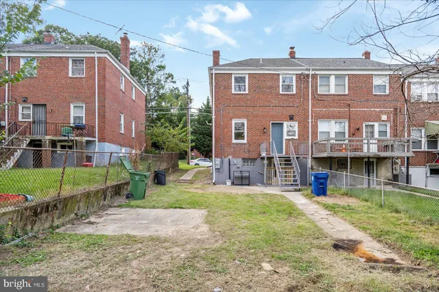 a front view of a house with a yard table and chairs