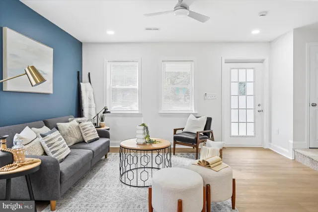 a living room with furniture and wooden floor