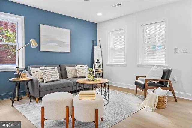 a living room with furniture and wooden floor
