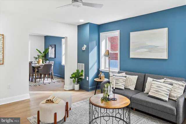 a living room with furniture kitchen and a table